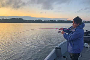 image of the hippie chick reeling in a fish