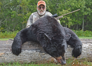 image of Mike Hagan with big black bear