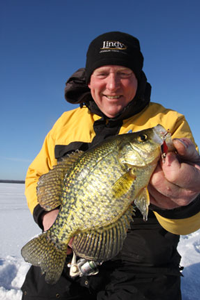 image of ice fisherman holding crappie