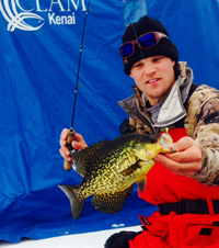 image of Reed Ylitalo holding large Crappie on the ice