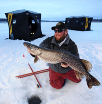 image of Pat Kalmerton with giant Pike on ice