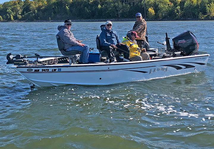 image of fishing guide Jeff Skelly using transom mount electric motor to position boat for drifting in current