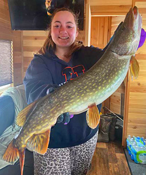 image of woman with big pike caught on lake winnie