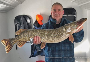 image of angler with big northern pike caught on lake of the woods