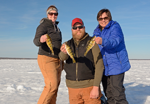 image of Susan Sundin with Annalee and Austin Jones perch fishing on Lake Winnie