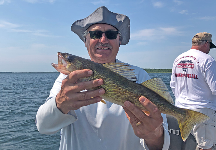 image of Tim Fishbach with nice wiggle worming walleye.