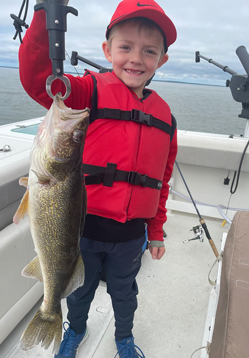 image of young boy holding nice walleye caught on Border View Charter Boat