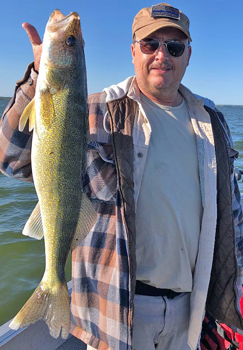 image of Mike Shannon with big walleye caught on lake winnie