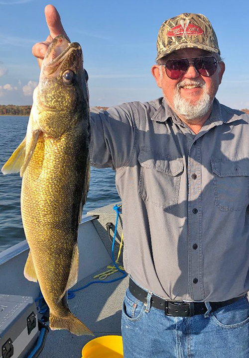 image of Ken Seufert with big walleye caught on lake winnibigoshish