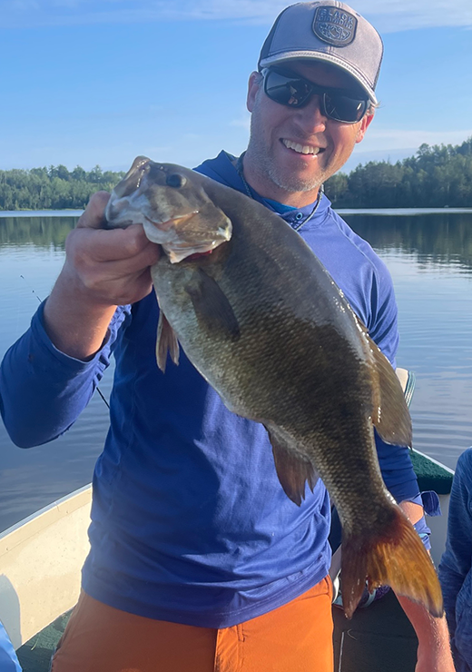 image of angler with big smallmout4h bass caught in the ely mn area