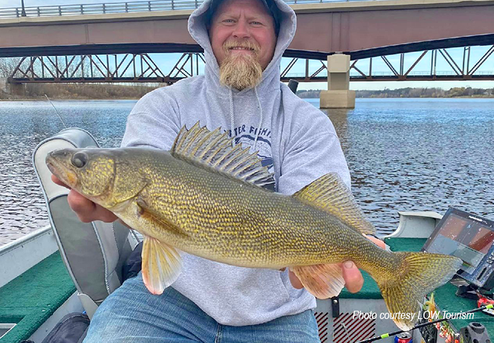 image of Charlie holding big walleye he caught while fishing on the Rainy River