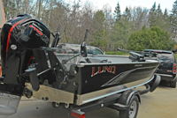 image of Jeff Sundin standing alongside his 2021 Lund Alaskan boat.