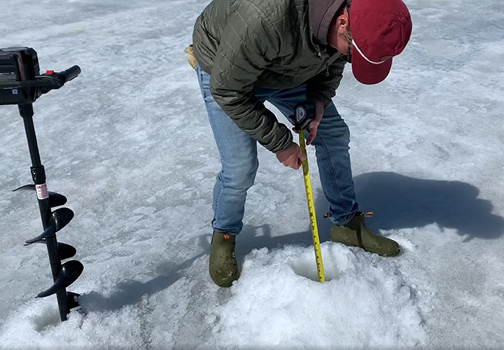 image of Jens Heig checking the ice conditions on Lake Winnie 