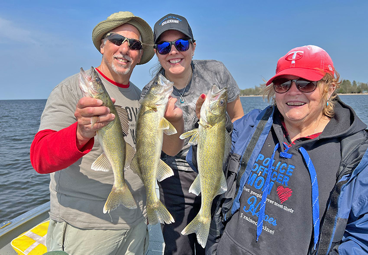 image of Joyce Damon Kelly Damon and Phil Goettl with walleye triple on upper red lake