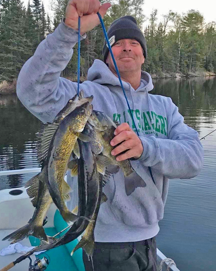 image of fisherman with limit of walleyes caught near Ely MN 