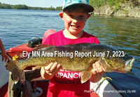 image of young boy holding large walleye