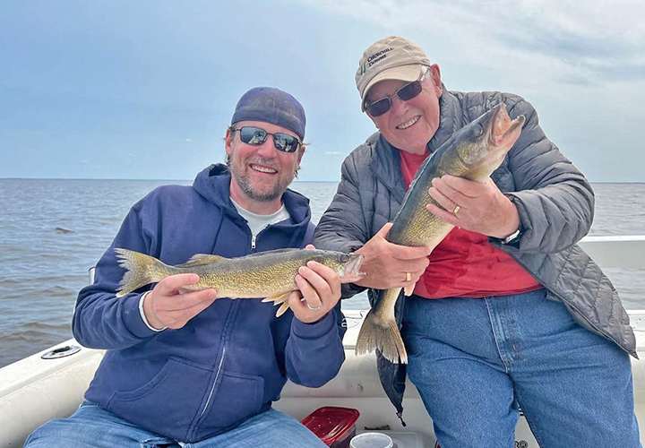 image of anglers holding a pair of nice walleyes caught on lake of the woods