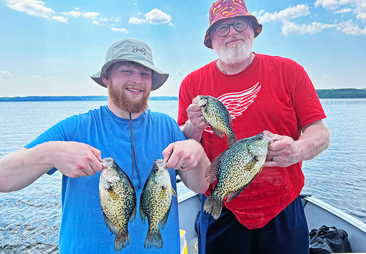 image of Kollin and Kurt Volkert holding nice crappies they caught near Deer River Minnesota