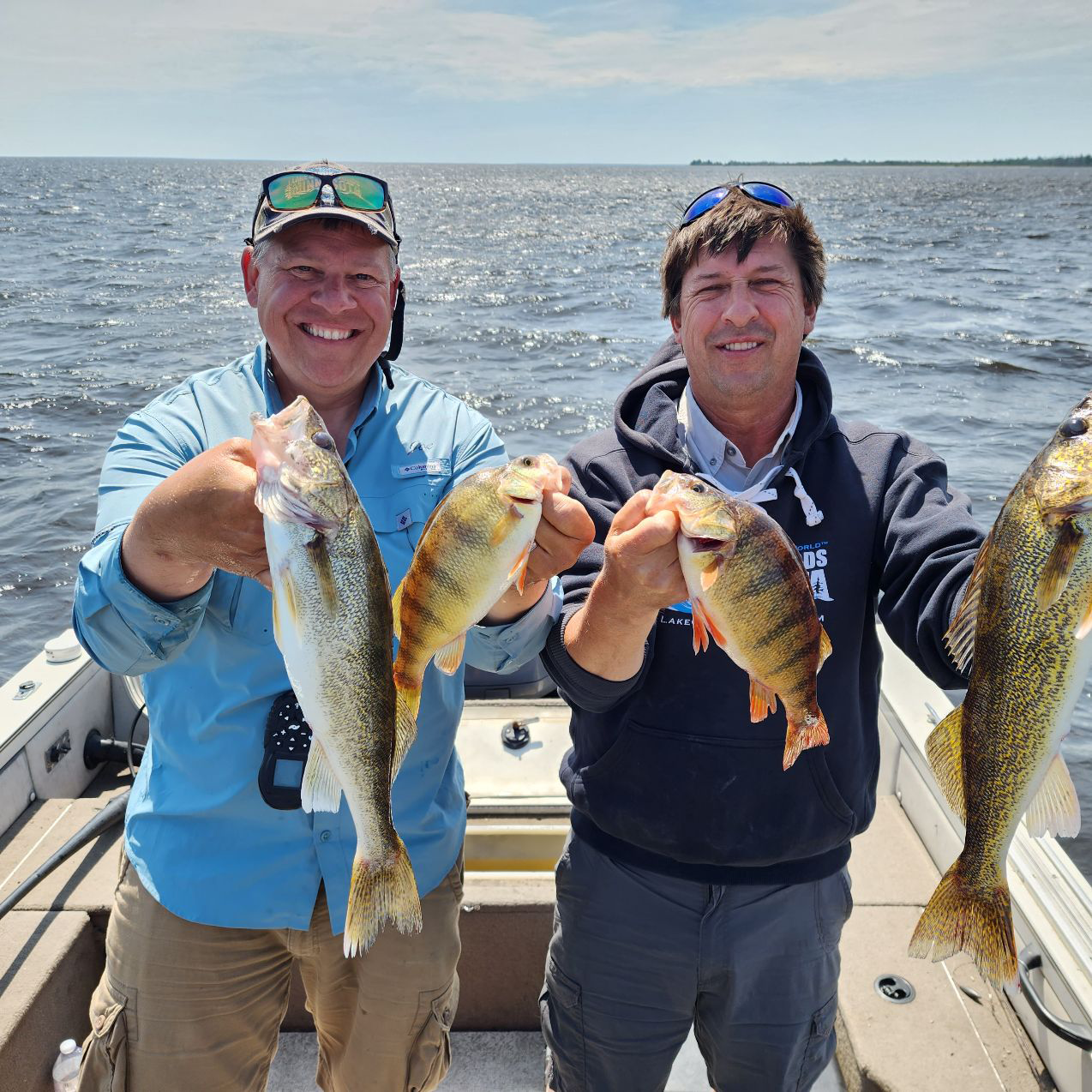 image of greg jones and joe henry holding walleyes and perch