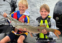 image of 2 young boys holding and sharing credit for a large northern pike caught on lake of the woods
