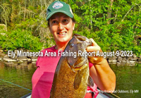 image of woman holding a big smallmouth bass