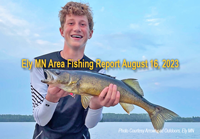 image of young man holding nice walleye caught near Ely Minnesota