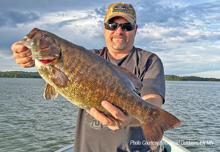 image of angler holding big smallmouth bass