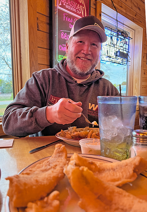 image of Tom Coen eating walleyes at Florio's Restaurant Cohasset MN 