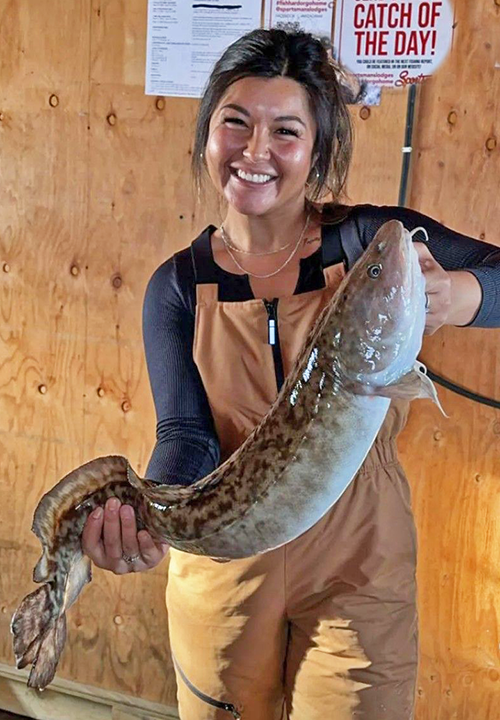 image of woman holding a large eelpout caught on lake of the woods