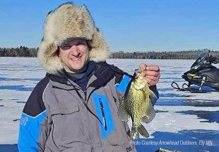 image of ice fisherman showing off nice crappie