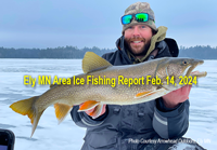 image of uce fisherman holding big lake trout caught near Ely MN
