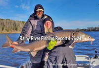 image of anglers holding a huge sturgeon caught on the Rainy River