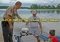 image of Minnesota conservtion officer checking licenses of anglers at the boat dock