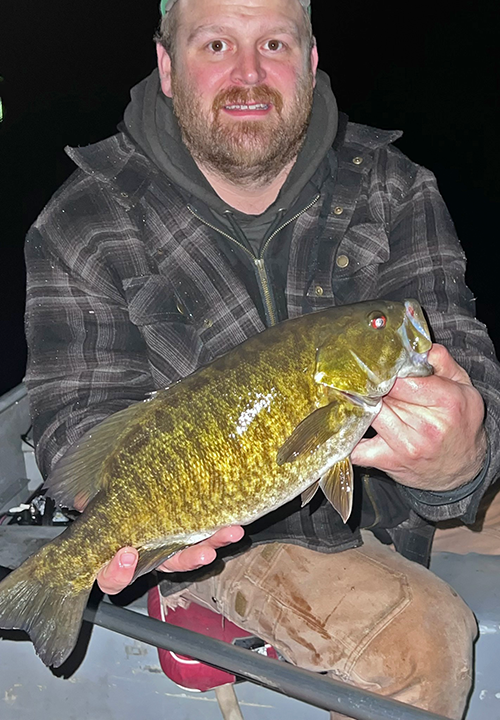 image of Patrick Everson with nice smallmouth bass caught after dark