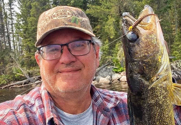 image of walleye angler holding nic fish caught near Ely MN