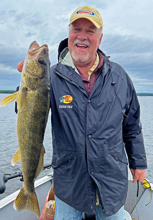 image of Don Jacobson holding big walleye he caught on fishing charter with Jeff Sundin 