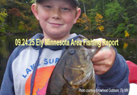 image of young boy holding big smallmouth bass