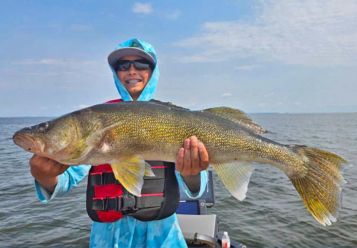 image of young man holding huge walleye caught on Lake of the Woods 
