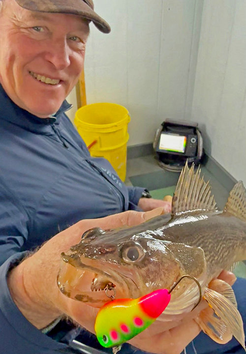 image of Jeff Sundin with sauger he caught using a Lindy Glow Streak