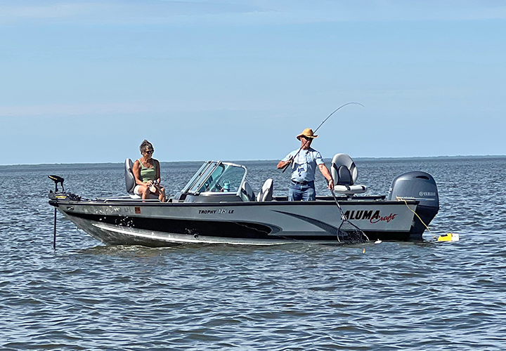 image of couple on their boat fishing at Upper Red Lake