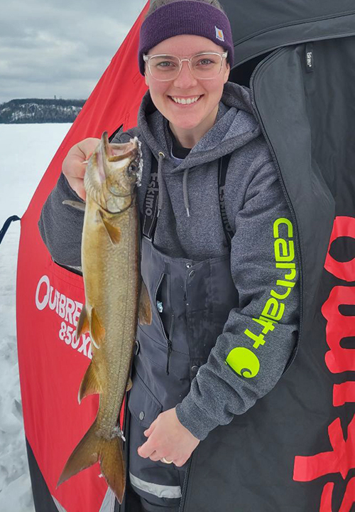 image of Joelle Bellamy holding nice lake trout caught ice fishing