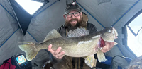 image links to fishing article about ice fisherman who caught a 12 pound walleye 
