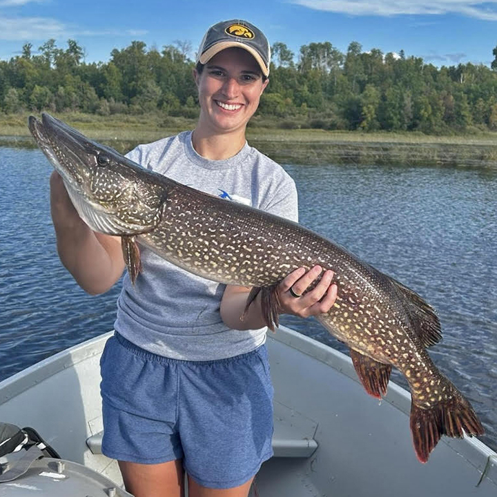image of woman holding big northern pike caught near Ely Minnesota