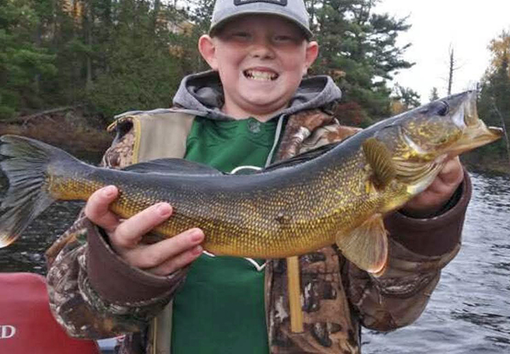 Ely Area Walleye image of young boy holding large walleye caught near the Ely MN area
