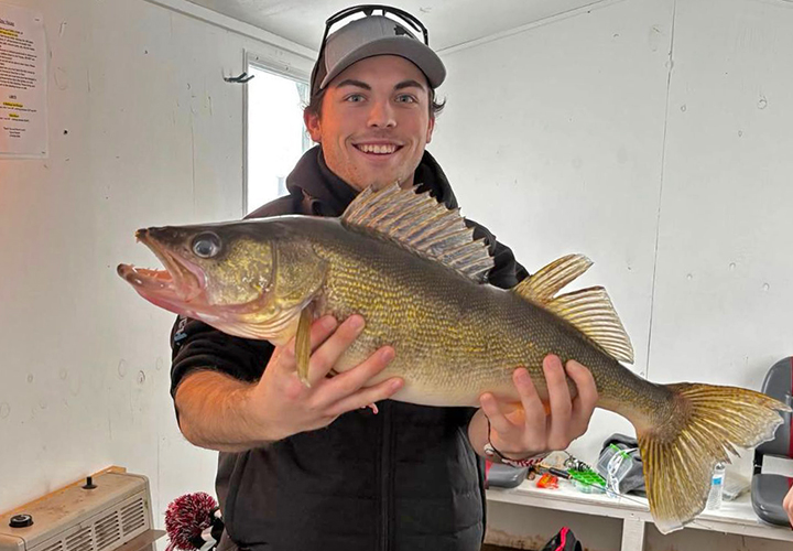 image of Ice Fisherman holding big walleye caught on Lake of the Woods 