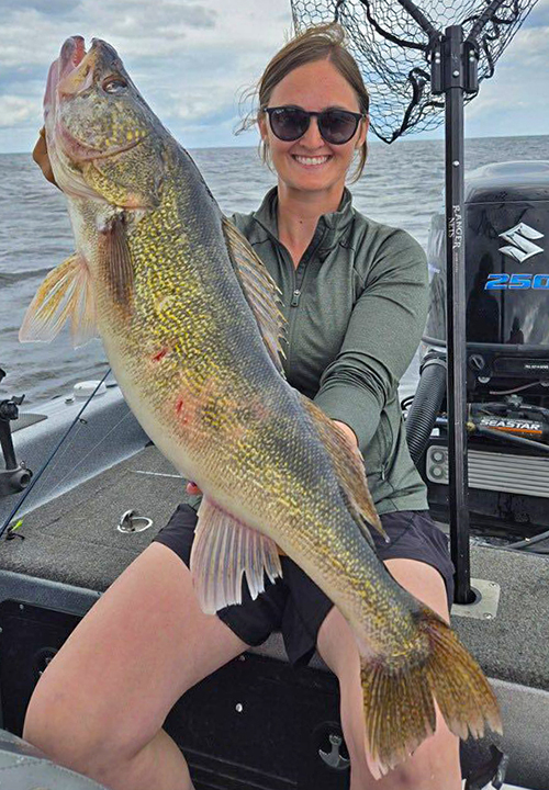 image of woman holding a huge walleye she caught during the Girls Gone Fishing Tournament on Lake of the Woods