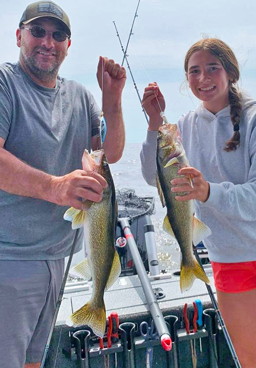 image of youg couple with walleye double caught on lake of the woods 