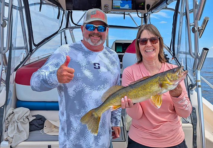 image of Tim "Wingnut" Hill with charter fishing customer who caught a nice walleye on lake of the woods