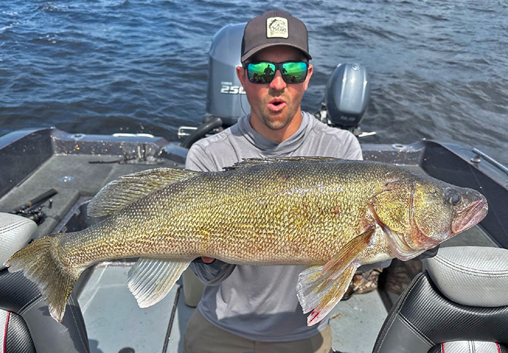 image of MTT Tournament angler holding huge walleye from Lake of the woods